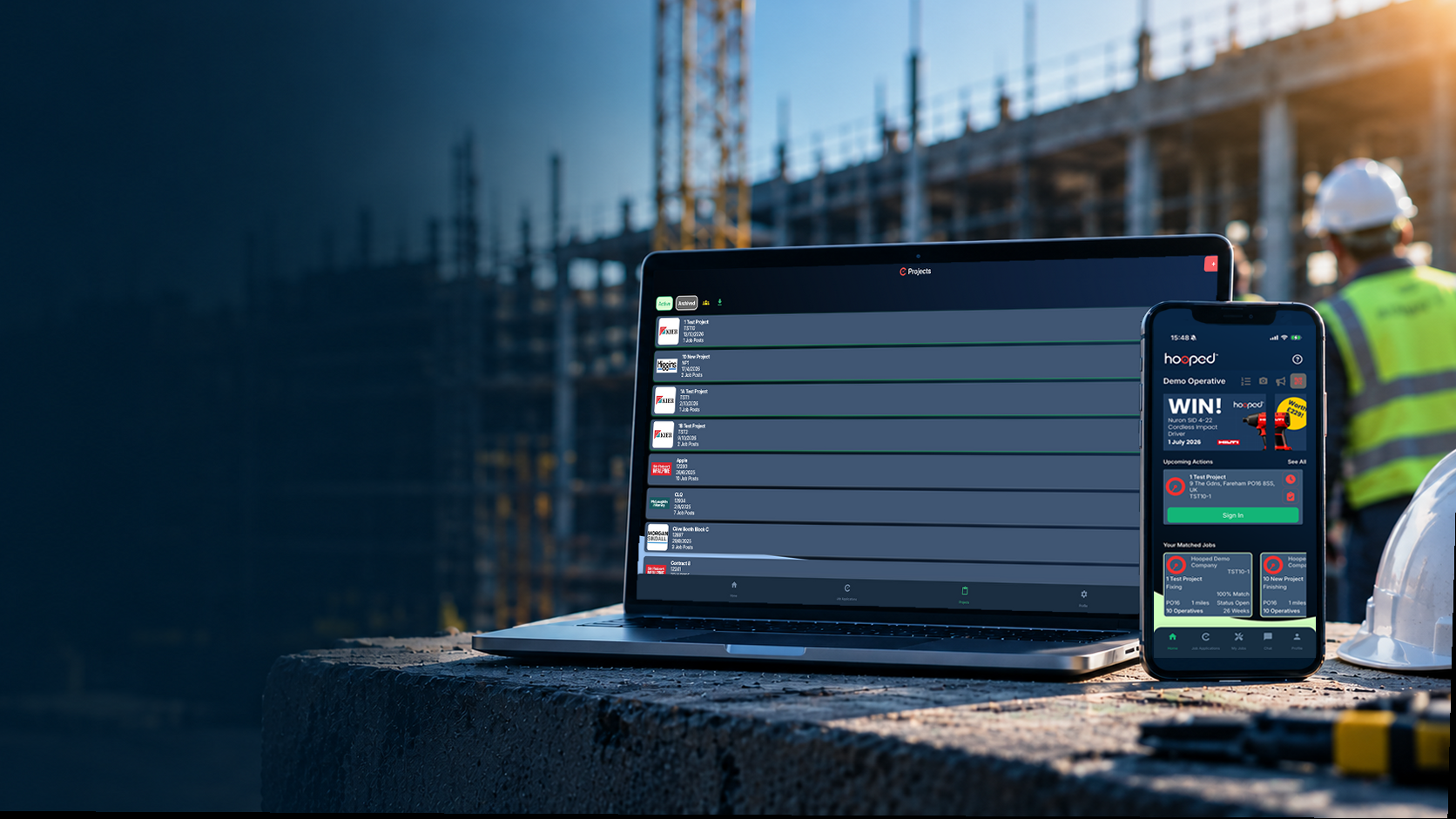 Hooped app shown on a laptop and phone on a construction site
